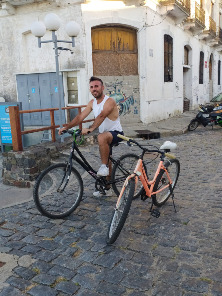 Adélin přítel, pózující na kole